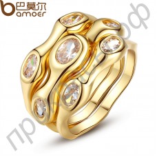 Красивое кольцо в виде трех колец оригинального дизайна с большими камнями по периметру в уникальной позолоте