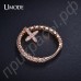 Интересное кольцо в форме маленького крестика с ясными швейцарскими фианитами в розовой позолоте